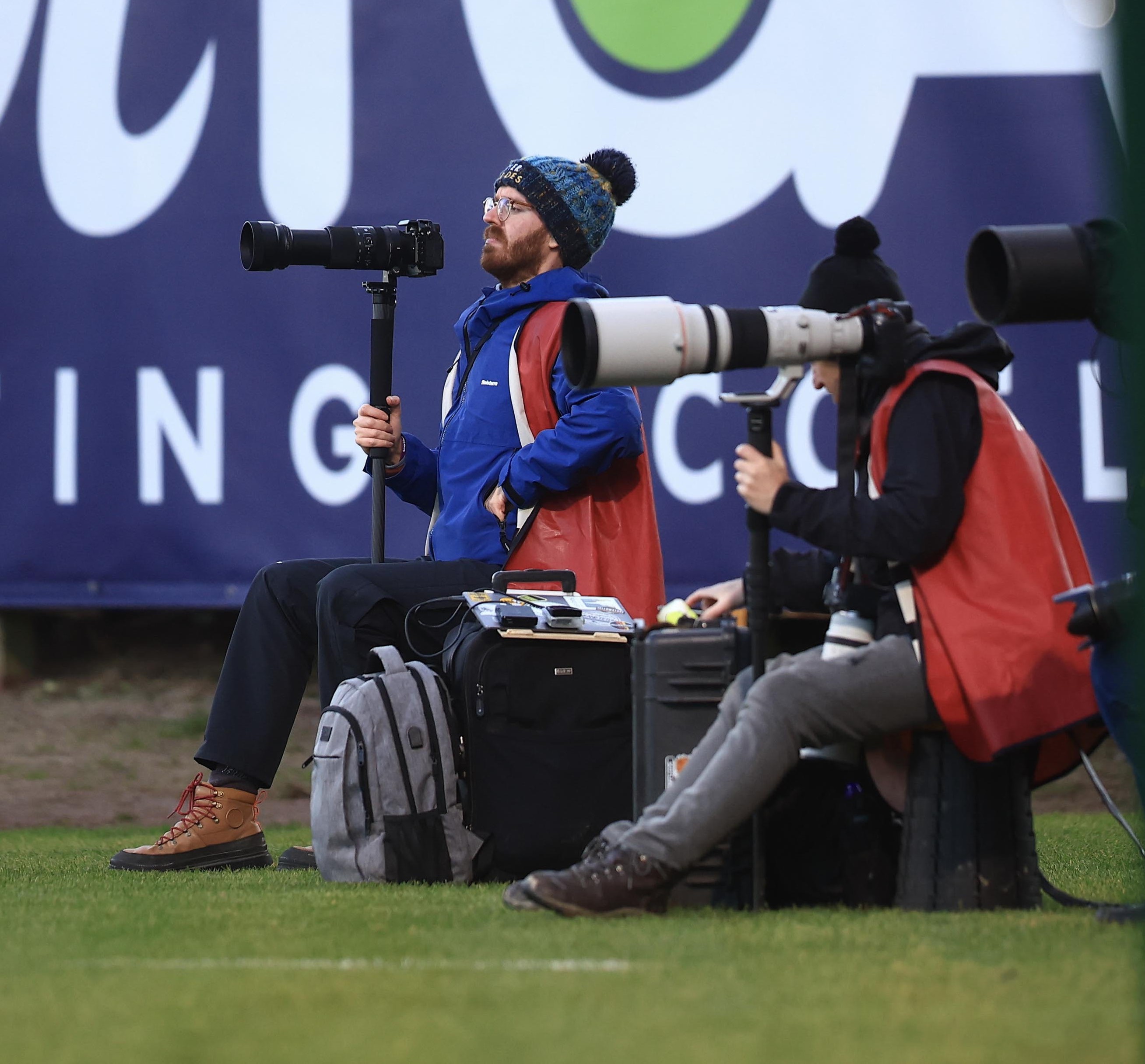 Shot of James Thomson taking photographs at a football match