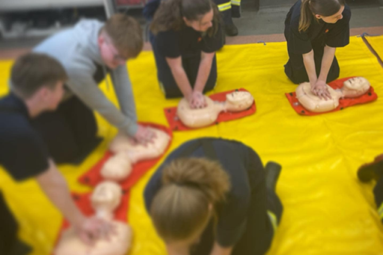 Pupils performing CPR training on dummies