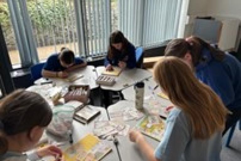 A group of children sitting at tables in a room