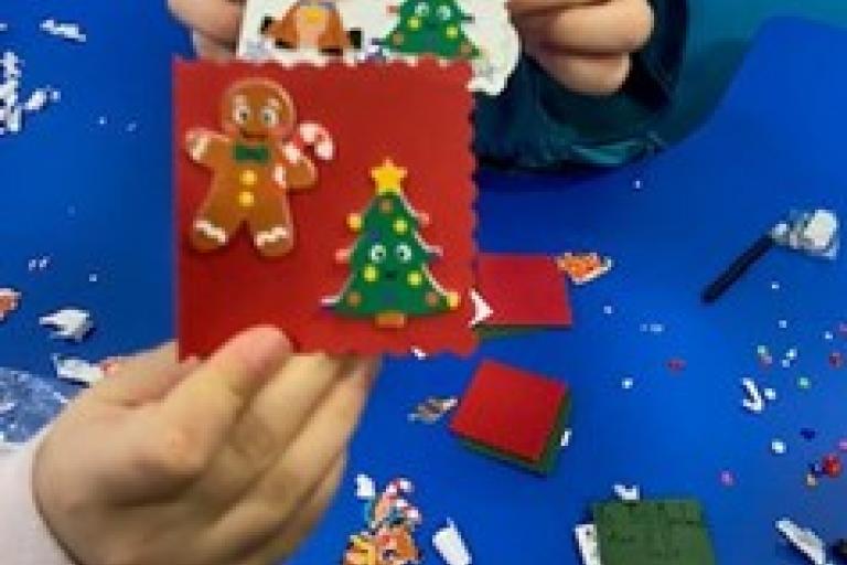 A child holding up a card