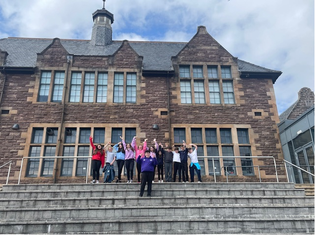 Pupils in front of a school